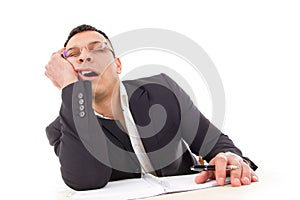 Tired businessman sleeping at work yawning