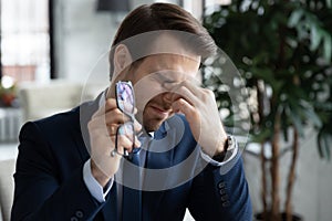 Tired businessman suffer blurry vision in office