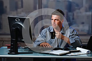 Tired businessman working late in office photo