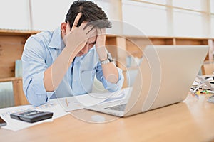Tired businessman at workplace in office holding his headache or angry. Overworking, making mistake, stress, termination, fail,