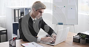 Tired businessman yawning and resting at office