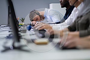 Tired Businesswoman At Desk