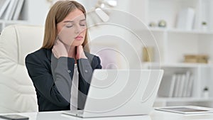 Tired Businesswoman having Neck Pain in Office