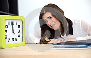 Tired businesswoman sitting at the table