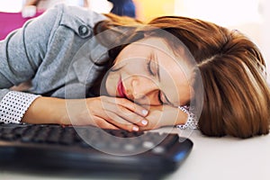 Tired businesswoman sleeping at office