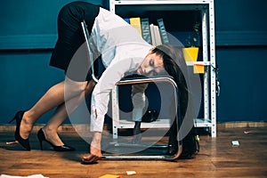 Tired businesswoman sleeping on office chair. Young exhausted pretty girl resting in unnatural pose, falling asleep on photo