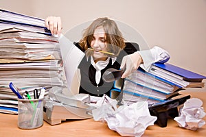 Tired businesswoman with telephones