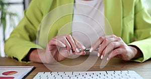 Tired businesswoman is waiting and tapping with pen table in office