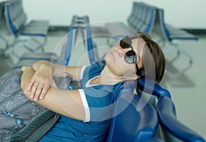 Tired caucasian woman sleeping in airport lounge waiting for flight