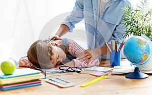 Tired child girl fell asleep when she did her homework at home