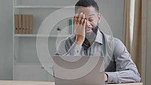 Tired clerical african american worker sit at desk with laptop falling asleep feels unmotivated exhausted make decision