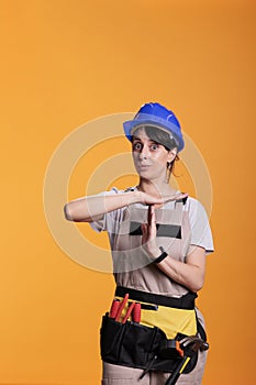 Tired construction worker expressing timeout sign
