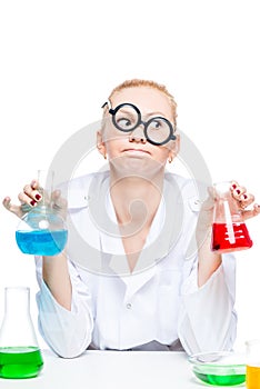 tired crazy chemist in glasses with test tubes conducting experiments in the laboratory