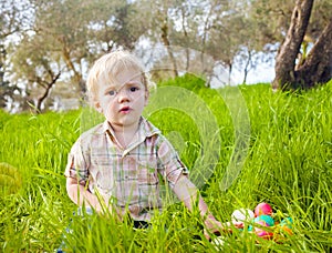 Tired cute child at Easter hunt