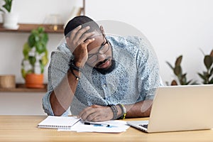 Tired depressed bored african businessman frustrated by business failure photo