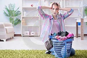 The tired depressed housewife doing laundry