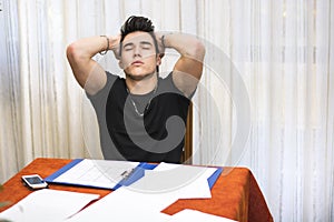 Tired or despondent young man doing homework photo