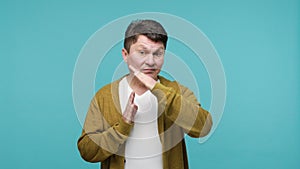 Tired dissatisfied man showing time out gesture with hands, need break