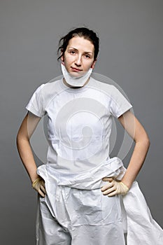 tired doctor female in a protective suit on the floor, exhausted in the fight against a pandemic covid-19