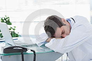 Tired doctor sleeping on his deck