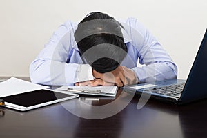 Tired doctor sleeping on his deck at medical office