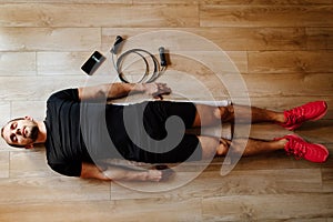 Tired and drained athlete lays on floor