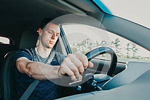 Tired driver falls asleep while driving car. Sleepy man wearing seat belt in auto. Risk of accident due to alcoholic intoxication