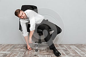 Tired drunk businessman resting in office chair