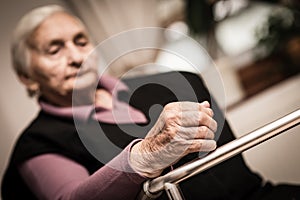 Tired elderly woman - focus on hand