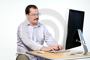 Tired employee in glasses asleep while working on photo