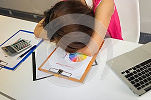 Tired employee sleeping in office after working hard