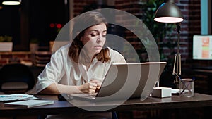 Tired employee struggling to remain focused at office desk, feeling overworked