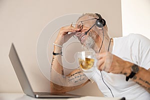 Tired entrepreneur rubbing his nose after working with laptop