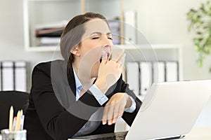 Tired executive yawning at office