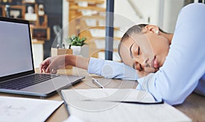 Tired, exhausted and business woman sleeping at her desk while working in a modern office. Burnout, sleepy and