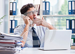 Tired exhausted businessman sitting in the office