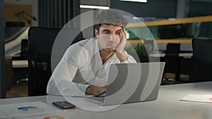 Tired exhausted Caucasian businessman bored fatigued male designer with computer project sad overworked overtime working