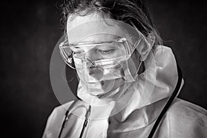 Tired exhausted doctor in personal protective equipment PPE photo