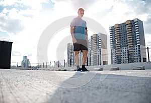 Tired Exhausted Middle-aged Man Resting After Running Outdoors. Handsome Runner Taking Break After Fitness Workout