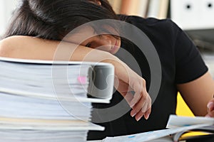 Tired and exhausted woman have a lot of work with documents fall asleep