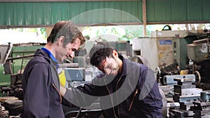 Tired factory workers taking a break and talking to coworker in the factory