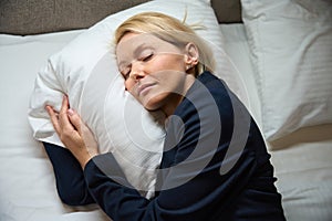 Tired female entrepreneur is dozing in her bedroom