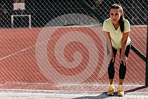 Tired female having break after workout on fresh air