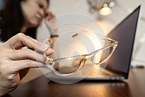 Tired female holding bad spectacles,problem of visual acuity test or inaccurate eye measurement error,woman wear non-standard