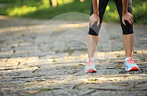 Tired female runner taking a rest after running