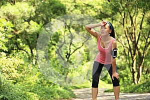 Tired female runner taking a rest after running