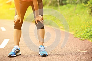 Tired female runner taking a rest after running