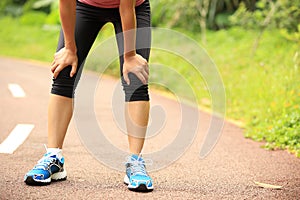 Tired female runner taking a rest after running