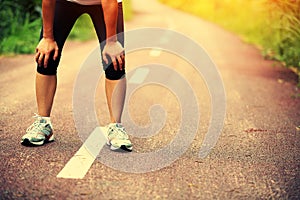 Tired female runner taking a rest after running