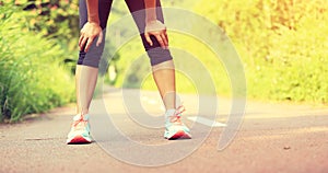 Tired female runner taking a rest after running